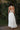Ruffled detail of girls ivory halter formal dress